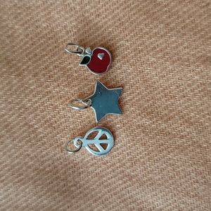 A trio of sterling silver pendants.